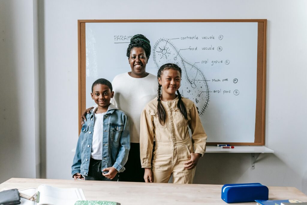 Smiling family standing together in a classroom with a whiteboard, symbolizing education and diversity.